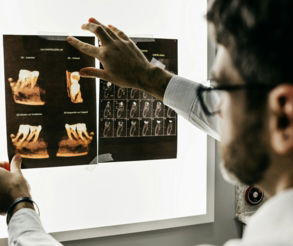 person in gray long sleeve shirt holding black tablet computer